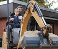 Joscha Fritzen, Landschaftsgärtner-Meister in Dirk Blaniks Unternehmen, zeigt den Vorschülern in der ev. Kita Gartenstraße das Baggerfahren.